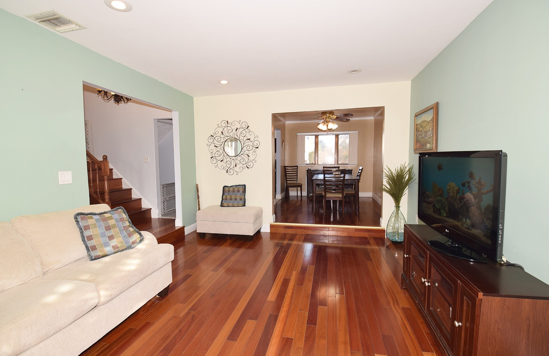 Living room at 1775 Adlin Court in East Meadow with hardwood floors and light green walls