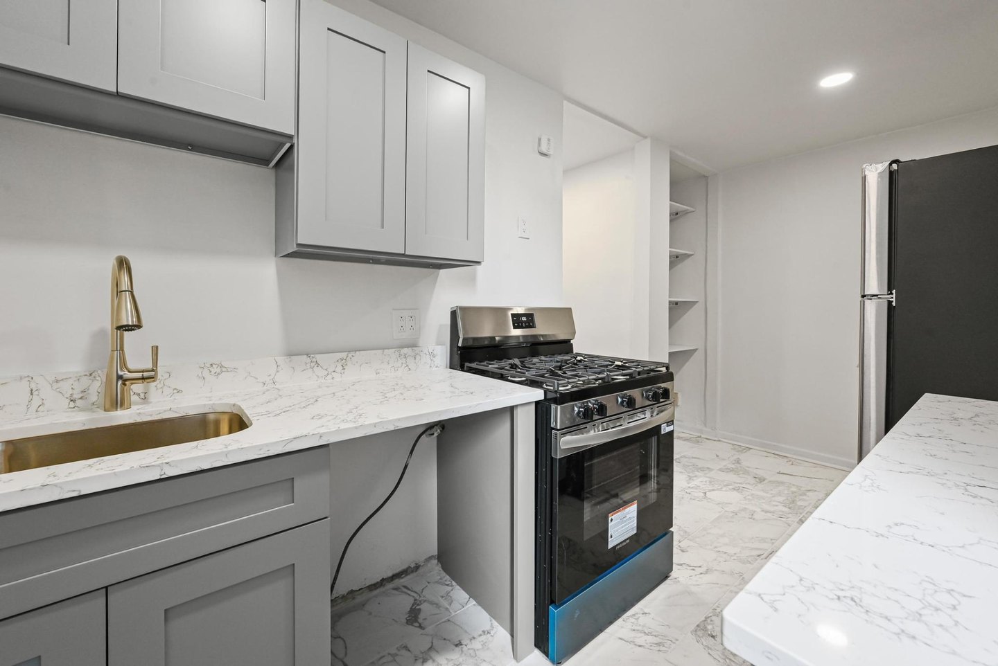 Renovated Jackson Heights co-op kitchen with new cabinets, counters, flooring and appliances