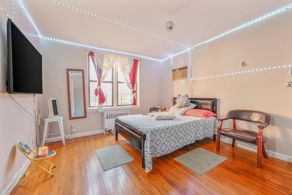 Occupied Jackson Heights co-op bedroom before renovation.