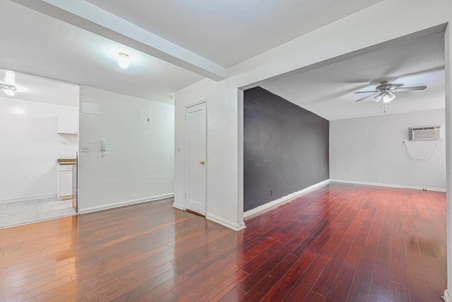 Vacant Jackson Heights co-op living area after the occupants and makeshift partition were removed, before renovation.